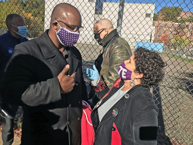 Mino Lora chats with then congressional candidate Jamaal Bowman outside of IN-Tech Academy during early voting last year. Lora, who wants to replace Andrew Cohen on the city council, has joined forces with fellow candidate Jessica Haller in hopes they can win on a ranked-choice ballot March 23.