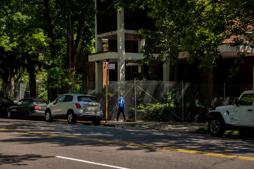 A pedestrian makes their way past the shuttered Church of the Visitation of the Blessed Virgin Mary which sits empty just across West 239th Street from Van Cortlandt Park. The city is negotiating a purchase of the property from the Archdiocese of New York, which could cost millions..