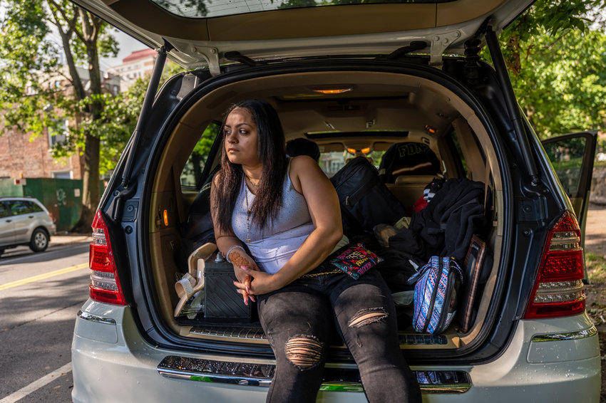 Jennifer Medina sits at the rear of her car where she keeps some of the things that belong to her and her son. Medina&rsquo;s family is at risk of being evicted from their home if state lawmakers fail to extend the existing pandemic-related moratorium that&rsquo;s right now preventing it.