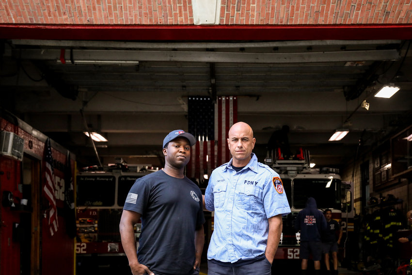 Jonathan Gilliam, left, and Capt. Anthony Rich stand outside the Ladder 52 firehouse. Both have led similar career paths leading them to the New York Fire Department, yet they have different memories of Sept. 11, 2001.