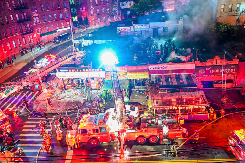 More than 160 firefighters converged on the intersection of West 238th Street and Bailey Avenue early Tuesday morning to fight a four-alarm blaze that severely damaged five business from Bailey Deli &amp; Grocery to Best Laundromat. The fire was just across the street from 181 W. 238th St., which displaced tenants in more than a dozen apartments there after a fire a little more than a month ago.