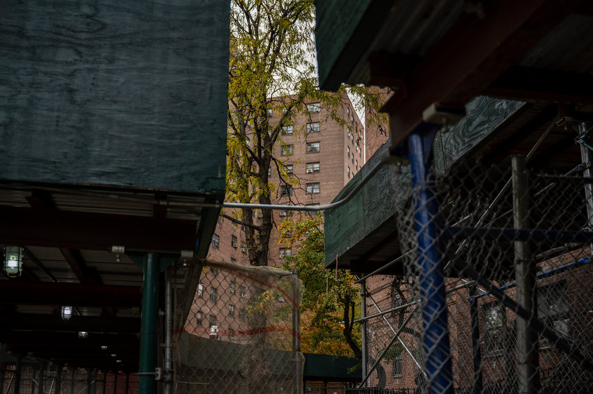 Sidewalk sheds line the perimeter of the buildings at Marble Hill Houses. Tenants say despite some benefits &mdash; like protecting pedestrians on the ground from debris falling from above &mdash; the structures are an eyesore and have overstayed their welcome.