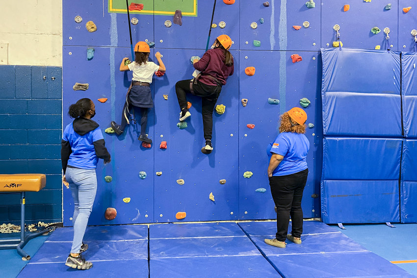Kids scramble up a climbing wall as part of Mosholu Montefiore Community Center&rsquo;s after-school program. Groups like this are limited &mdash; especially at locations away from MMCC&rsquo;s main Dekalb Avenue center &mdash; because of staffing shortages, creating a waitlist of more than 400 kids.