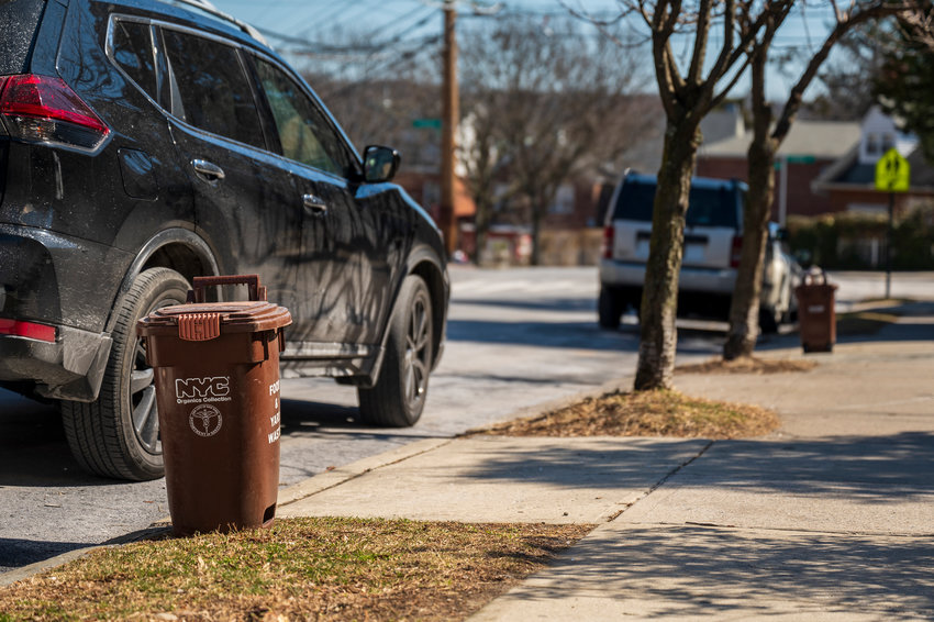 New York City Department of Sanitation composting bins which remains in affect despite the budget cut is placed on the curbs of homes along the street of Riverdale Ave and 259th.