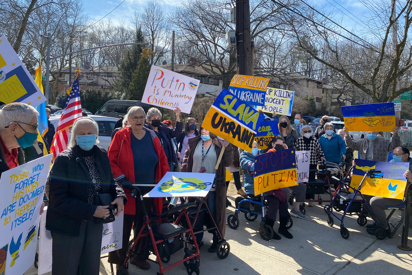 Residents from the Hebrew Home at Riverdale and it RiverWalk community hold up signs during a protest of the war in Ukraine in front of the Russian Mission compound on March 15.