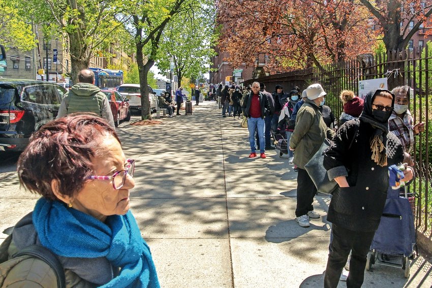On a Friday afternoon in late April, Kingsbridge residents wait for hours outside a food pantry organized by The Church of the Mediator. In the past couple of months, the lines have grown longer and longer, organizers say.