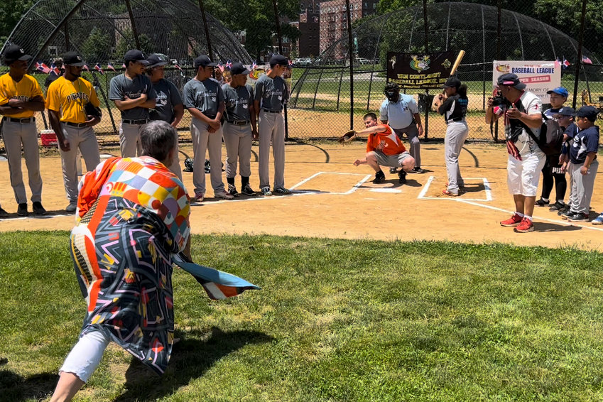 Deb Derella Cheren threw out the first pitch for opening day of the Van Cortlandt Park Baseball League on Saturday, June 4. A GoFundMe set up in her late husband Ivan&rsquo;s honor is helping local baseball families afford the costs of travel, equipment and private lessons.