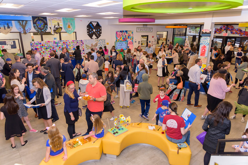 SAR Academy students, parents and faculty attend the school's recent art exhibit at Harvest &amp; Bloom.
