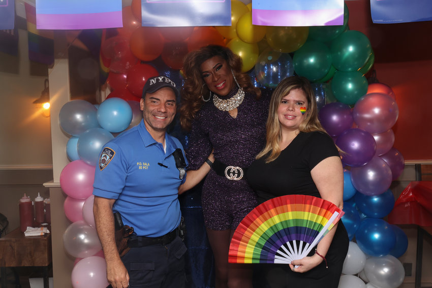 Officer Cesar Sala, Kelly Kaboom, and owner Laura Levine-Pinedo celebrate pride month at the Riverdale Pride Day event at the Bronx Burger House in the Bronx, New York, June 12.