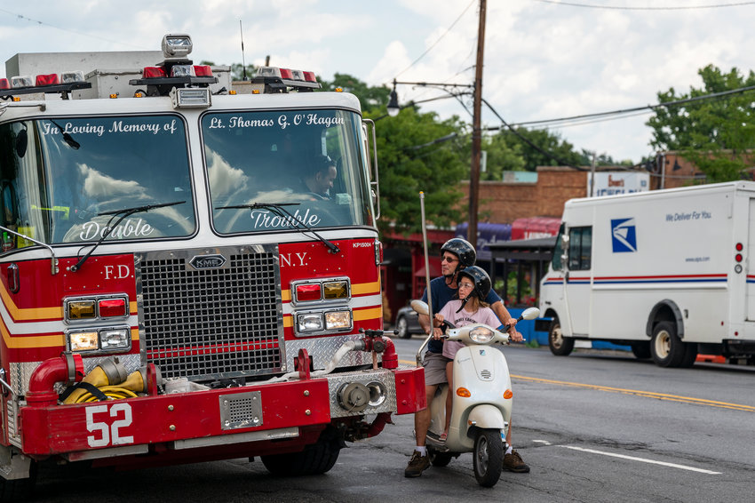 FDNY Engine 52 stops to have a conversation with locals on a Vespa on Monday, August 8, 2022.