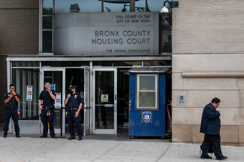 Security guards stand watch at the entrance to Bronx Housing Court Wednesday, Sept. 7, on Grand Concourse and E. 166th St. The court is the only one in the city continuing to conduct virtual intake and Right to Counsel eligibility screening for more than 3,000 eviction filings every month&mdash;by far the highest filing rate of any county in New York state.