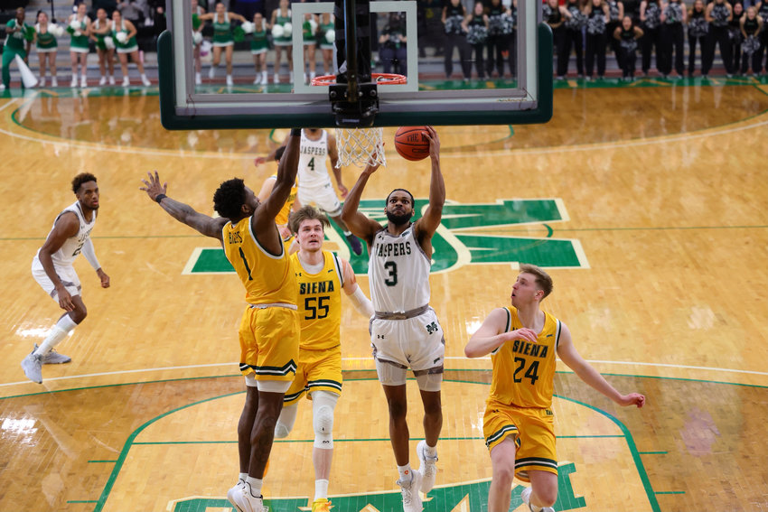 Manhattan&rsquo;s Ant Nelson drives to the hoop against Siena in a game the Jaspers won 71-66. Nelson scored the game-tying basket with four seconds left, which forced overtime before Manhattan ran away with a 14-9 margin in the additional minutes. It capped off Manhattan&rsquo;s eighth win of the season.