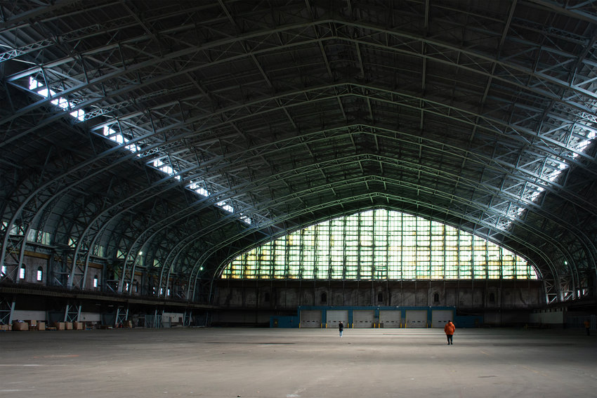 Two participants in the March 11 tour of the Kingsbridge Armory make their way across the cavernous drill hall, their figures shrinking to specks on the other side. This room has an area of 180,000 square feet, large enough to contain three football fields.