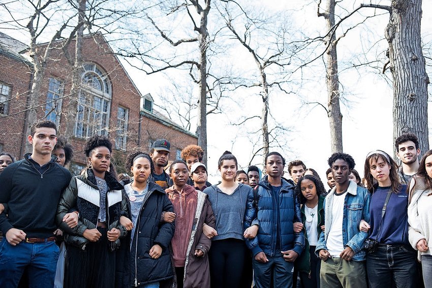 Ethical Culture Fieldston School students lock arms outside the campus as a sign of solidarity following a press conference about the progress students made in their demand for reforms from the administration. Last month, a years-old video showing five students from the school uttering racial epithets went viral.