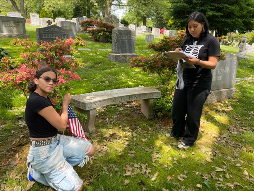 During its annual flag placement ceremony, the Woodlawn Cemetery and Conservancy placed 8,600 American flags next to grave sites the week before Memorial Day. There were more than 1,500 volunteers that included Boy Scouts, members of Community Board 7, the city&rsquo;s veterans affairs department, and St. Barnabas High School students. Volunteers, at left, registered for placing flags utilizing a mapping system for those veterans buried at Woodlawn. Above, the owner of a home on Fieldston Terrace festooned his front yard with flags of the Bronx, the United States, New York state and New York City in commemoration of Memorial Day.