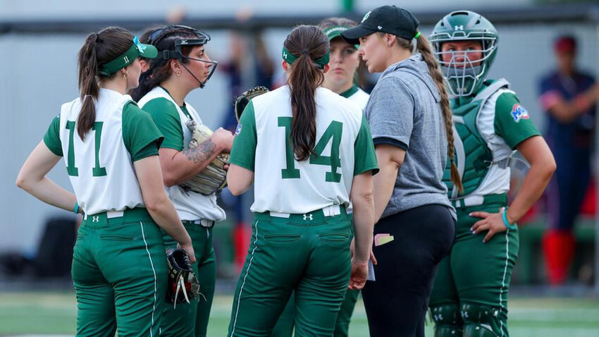 Former coach Cat Clifford is shown in a mound meeting this past season in a game against Canisius. Clifford left her helm after two seasons just before a penalty for a recruiting violation was levied by the NCAA.