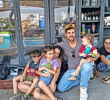 The Ades family was happy to have escaped their kibbutz on Oct. 8 after 36 treacherous hours following the Hamas attack on Israel. From left, Ori, 7; Shir, 5; Amit; Tomer and Ellie, 20 months at a gas station after being rescued.