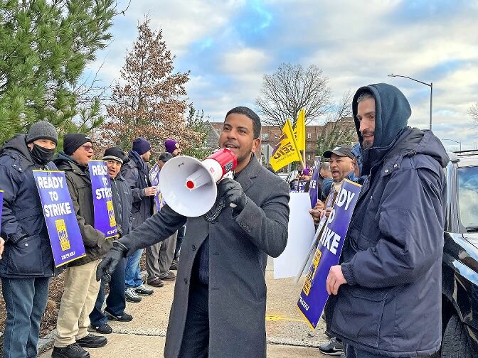 SEIU 32BJ delegate Aneury Rodriguez uses a megaphone to get his fellow union workers going with some words of inspiration during the Feb. 21 rally at Skyview Riverdale.