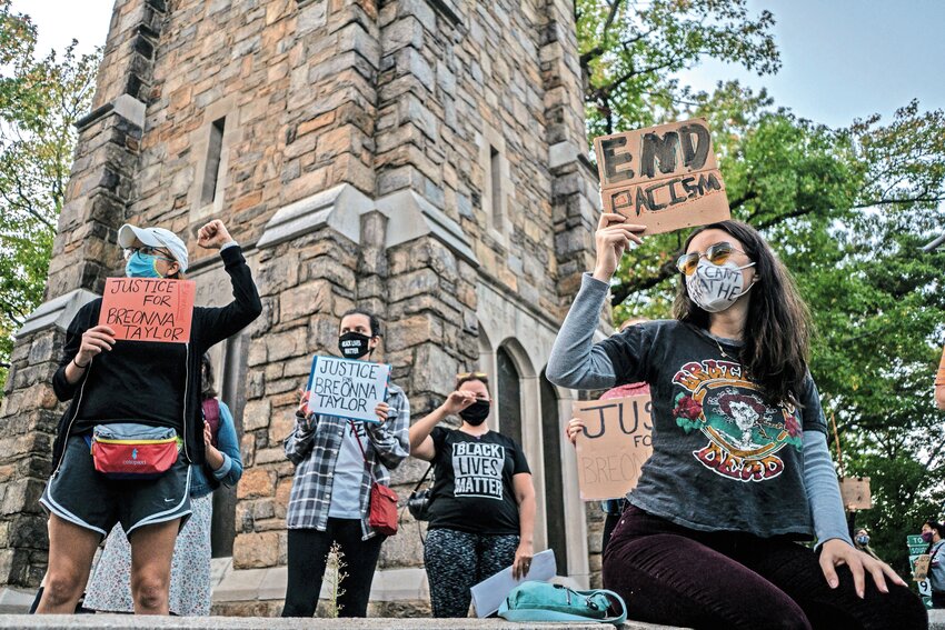 A group from the Black Lives Matters movement stand with signs at the Bell Tower Monument in 2020. Protestors called for justice for Breonna Taylor, who was fatally shot inside of her apartment by police officers on March 3, 2020. While a pair of bills in Albany would not necessarily target protest groups like these, many who regularly protest believe it could have a chilling effect on protests overall.