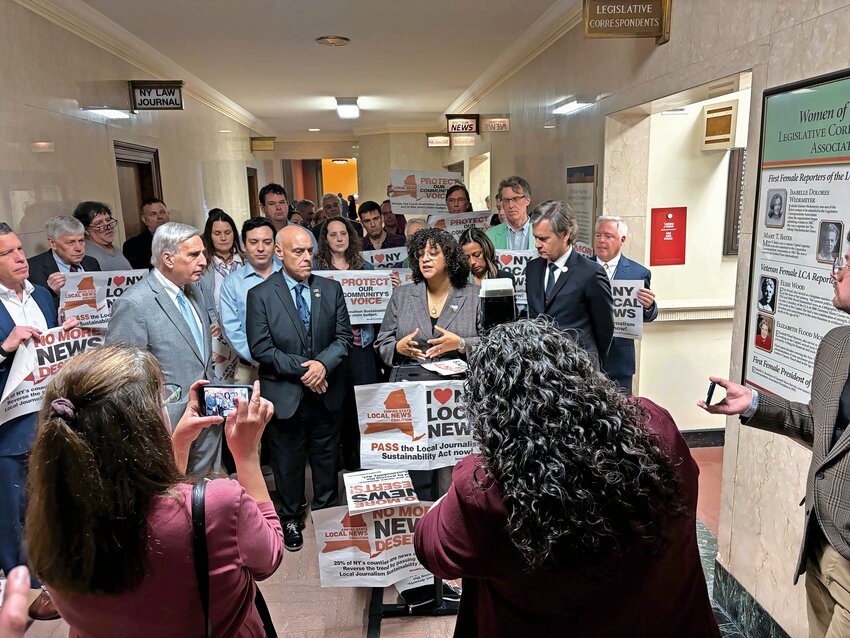 Assemblywoman Michaelle Solages of Long Island joins lawmakers and supporters like Assemblyman David Weprin, at left, and state Sen. Brad Hoylman-Sigal, at right, to call on her colleagues to support the Local Journalism Sustainability Act. The measure &mdash; currently included in the senate&rsquo;s One House budget &mdash; would provide tax credits to local news outlets, so they can keep local reporters on the ground and covering communities.