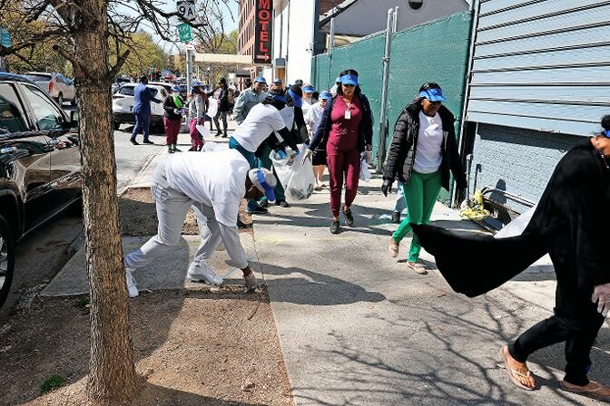 Residents at The W Assisted Living at Riverdale circle the block collecting trash from the sidewalks and curbs as part of Earth Day.