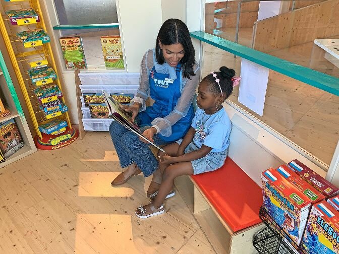 Rayne Davis, 4, reads Hair Love by Matthew A. Cherry with Jessica Jackson, the museum