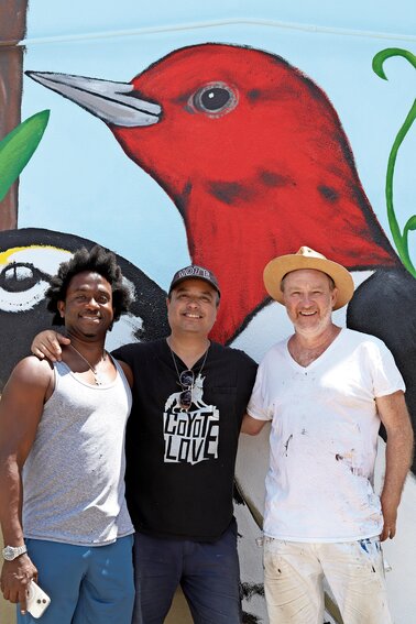 Nicky Enright, center, along with Olugbala Williams, left, and Nils Folke Anderson were the primary artists on the mural outside Studio Delaj on 236th Street.