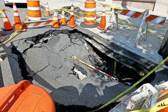 The sinkhole outside 3174 Riverdale Ave. was first reported to the city in mid-June by residents and again by The Press on July 8.