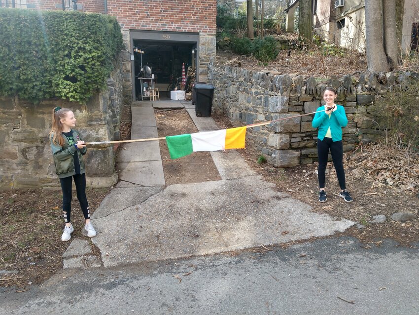 When John Kelly started his grassroots St. Patrick's Day parade in 2020, he scrapped together what he could in a last minute effort to create community as the world was shutting down. The picture shows his twin daughters holding his makeshift Irish flag banner made of miscofiber rags stapled to a stick.