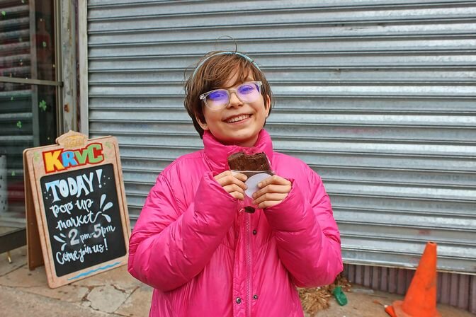 Angelina &ldquo;Nina&rdquo; De Cesare, a spirited Girl Scout from Inwood, ventured to Riverdale with her mother, Adriana De Cesare, to deliver Girl Scout cookies. On their way, with Samoas and Thin Mints in hand, the duo discovered the Women&rsquo;s History Month Community Pop-Up and couldn&rsquo;t resist a stop at Sweet Note Bake for a sweet treat of their own. Nina gave the freshly baked brownie a perfect &ldquo;10 out of 10,&rdquo; rating in between bites.
