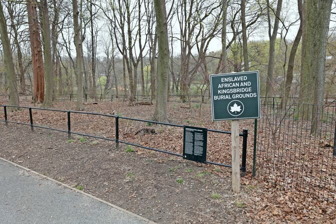 The Parks Department sign is one of the only visible markers identifying the Enslaved African Burial Ground in Van Cortlandt Park.