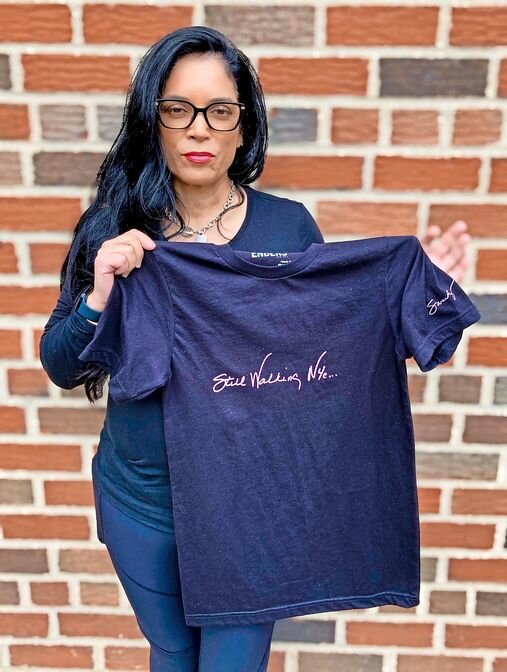 Ivonne Sanchez, retired FDNY EMT, debuts the first Enders Project&rsquo;s &ldquo;Still Walking NYC&rdquo; t-shirt, featuring her very own signature.