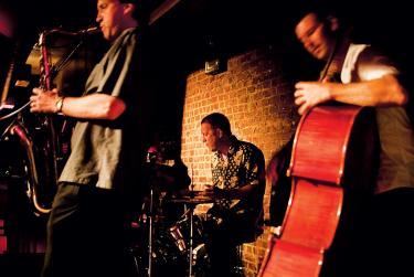 Joe Farnsworth, center, performs alongside bassist John Webber, right, and alto saxophonist Mike DiRubbo.

Photo by Karsten Moran