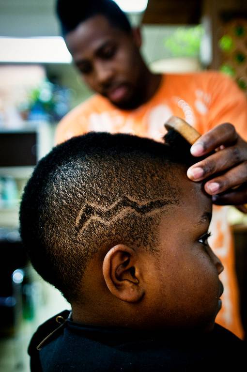 Barber Craig Butler gives his little brother Antwone a lightning bolt buzz.