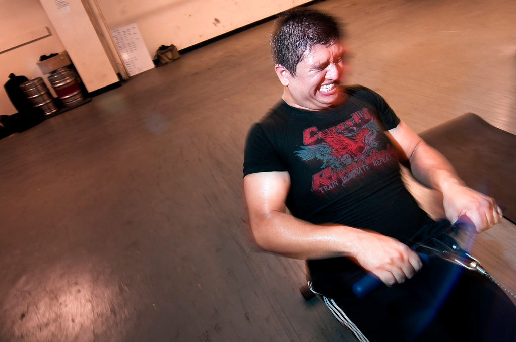 William Ortiz, from Pelham Parkway, strains as he completes a set on a rowing machine.