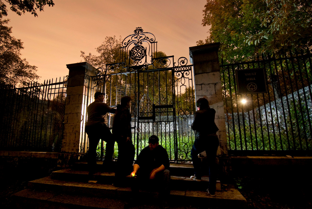 Members of the ‘Metaphysical Investigations: Search & Test Society’ stand at the gates of the Van Cortlandt’s Vault Hill burial plot on Saturday night.