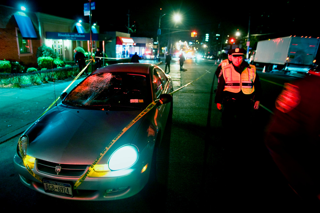 Police officers survey the scene of a fatal accident on Riverdale Avenue near West 261st street on Monday evening.