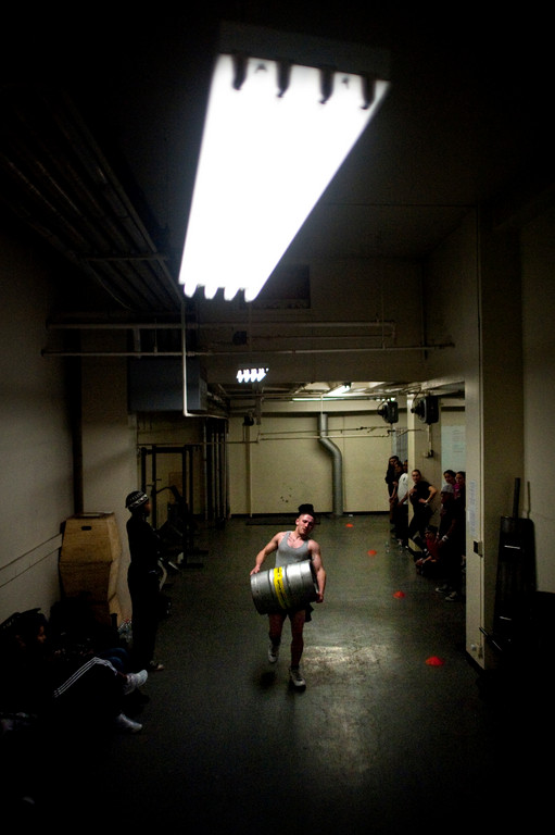 Ben Kaminski carries a  160 lb keg across the gym as he competes in the sandbag and keg-carrying medley.