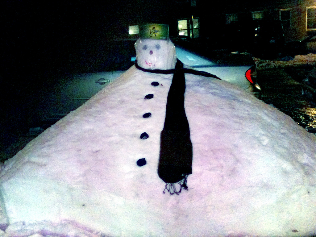 A rather hefty snowman stand his ground in front of 'Nails on Fieldston' on Fieldston Rd.