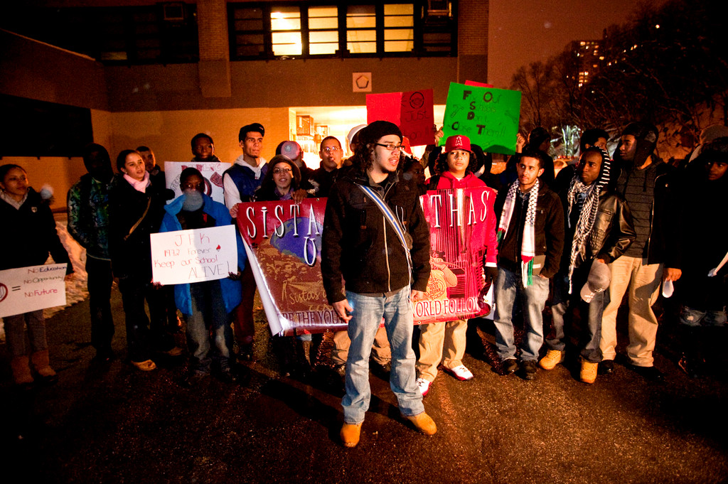 Rafael Pena, who graduated from Kennedy high school in 2007, leads a group of students and activists in a rally outside the school before the meeting.