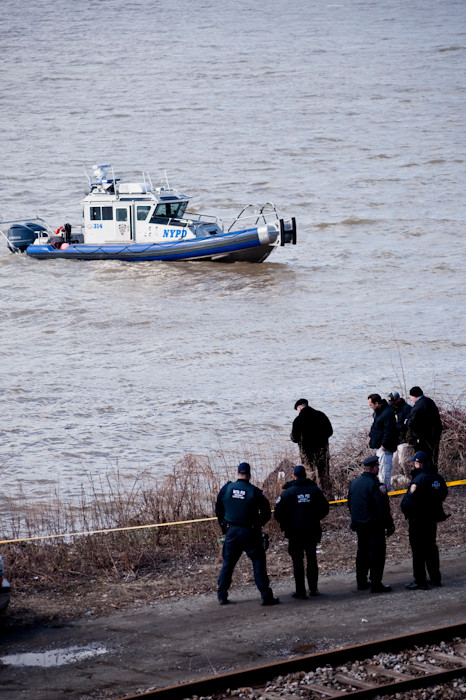 NYPD and MTA officials gather at the edge of the Hudson River, south of the Riverdale train station, March 24.
