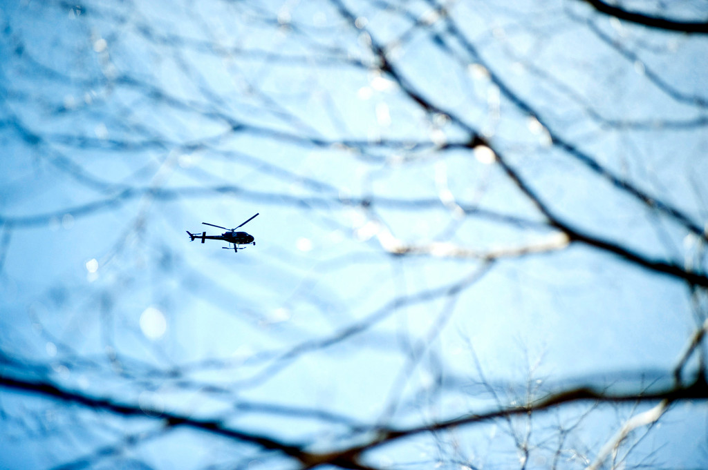 A Fox 5 news helicopter circles above Riverdale Park on Monday morning where crime scene investigators, as well as NYPD and DEA personnel, search for what is presumed to be a corpse.