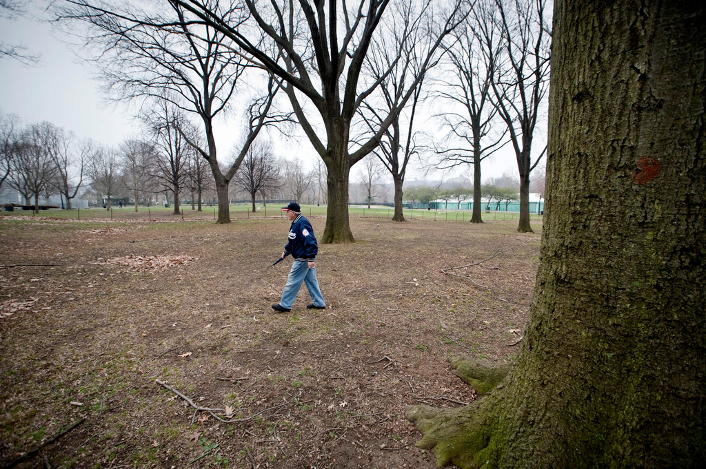 Veteran Herb Barret walks through memorial grove on Monday morning.