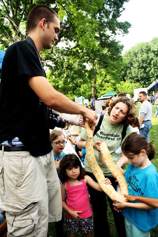 Erik Zeidler, of EZ Reptile Shows, holds an albino Bermese python for visitors to Riverfest on June 12.