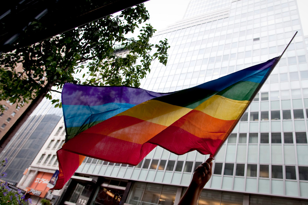 A parade goer waves her flag during the Manhattan gay pride parade on Sunday.