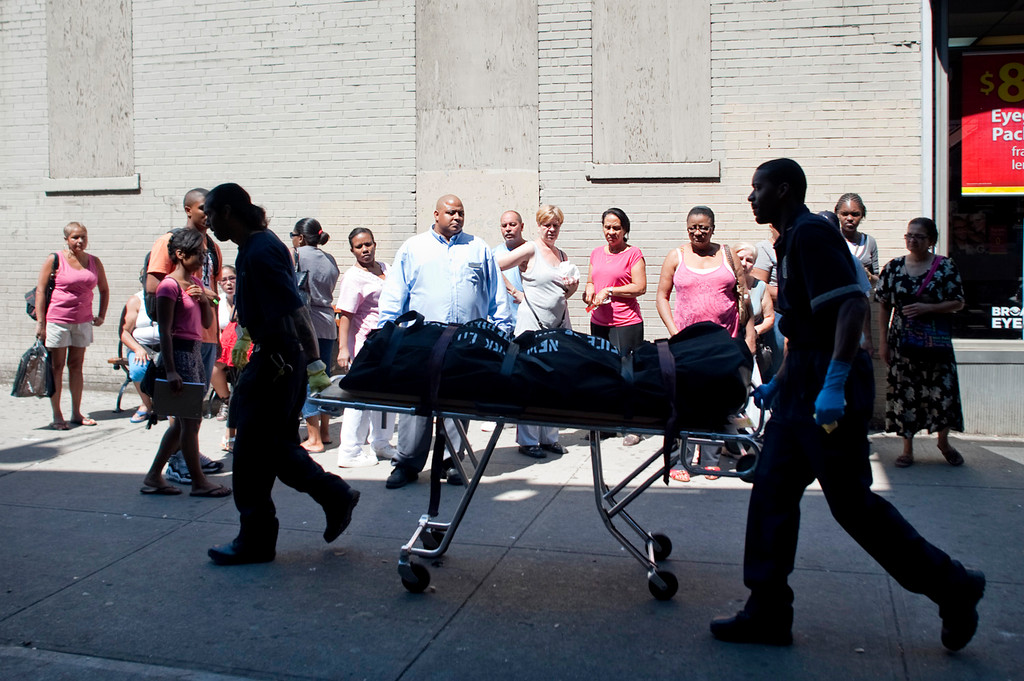 Personnel from the medical examiner's office  transport the remains of a woman who jumped in front of a No. 1 train as it was pulling into the West 231st Street station on Thursday morning.