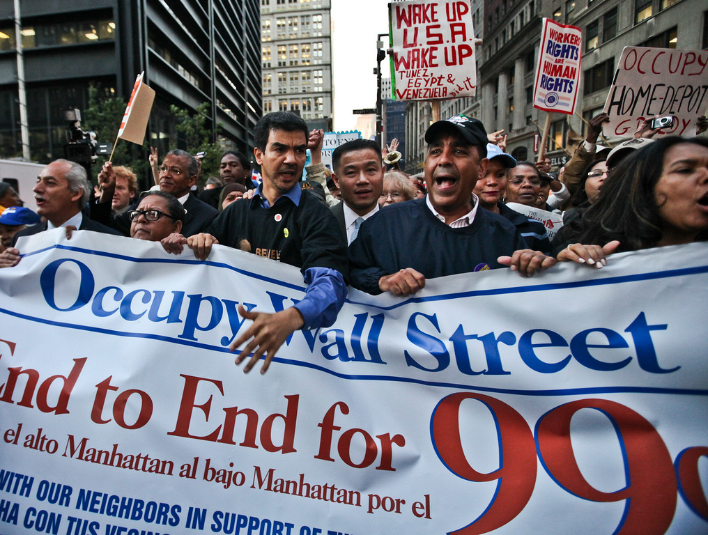 In center from left, Councilman Ydanis Rodriguez, New York City Comptroller John Liu and state Sen. Adriano Espaillat lead a group of protesters to Zuccotti Park on Nov. 7.