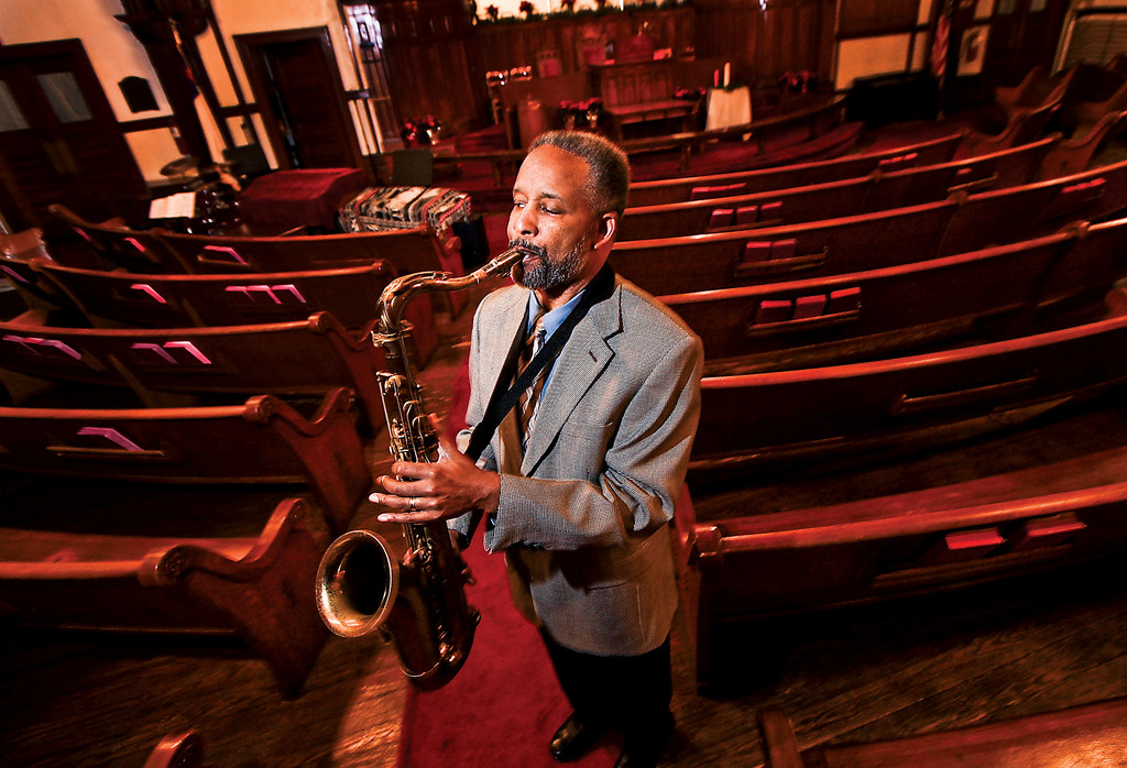 Rev. Nathaniel Dixon,
pastor of St. Stephen’s United Methodist Church, belts out a couple of notes on his tenor saxophone Nov. 29.