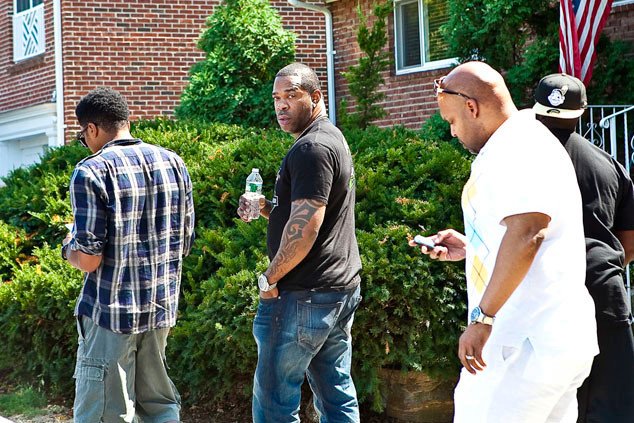 Mourners, including Busta Rhymes, center, gather outside of Chris Lighty’s home on the day of his death.