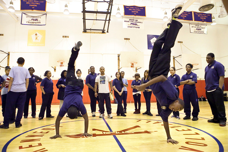 Jubori Chaplin and Floyd Bobb, ninth graders at New Visions Charter High School for Humanities, practice handstands at a Capoeira class on Sept. 14.